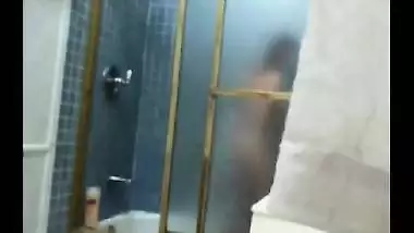 Indian girl fingers her hairy pussy in Shower